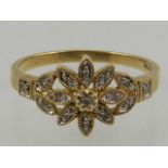 A 9 carat yellow gold and diamond floral cluster ring.