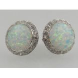 A pair of silver, opalite, and cubic zirconia circular stud earrings.