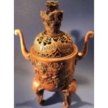 A Chinese metal lidded incense burner decorated with Lions, bats and a upon the lid,