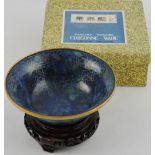A blue enamel cloisonné dish, with dense lotus decoration, on carved wood stand D. 15.