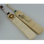 Two miniature autographed cricket bats, one signed by Graham Hick,