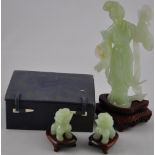 A carved jade figure of a courtesan playing Chinese bells, on carved wood base, H: 23cm,