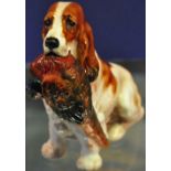 A Royal Doulton porcelain model of a seated spaniel with pheasant