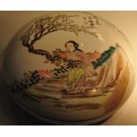 A Chinese glazed ceramic lidded dish decorated with a young girl beneath a cherry tree, Dia.