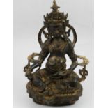 A Chinese cast metal study of a seated deity. H.24cm