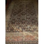 An indigo ground Tabriz rug, decorated with scrolling foliage to centre. L.310cm W.211cm