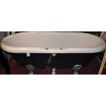 A Victorian style acrylic roll-top bath on silver painted shell ball feet