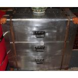 An industrial style wood bound leather mounted riveted aluminium three drawer chest