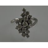 A diamond cluster dress ring of asymmetrical form,