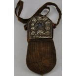 A Tibetan Buddhist icon in a portable pouch with shoulder strap