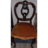 A set of six Victorian walnut balloon back dining chairs with pierced scroll splats on slender