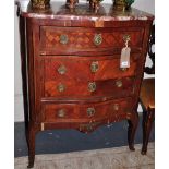 A Louis XVI design marquetry inlaid serpentine chest with rouge marble top over four drawers on