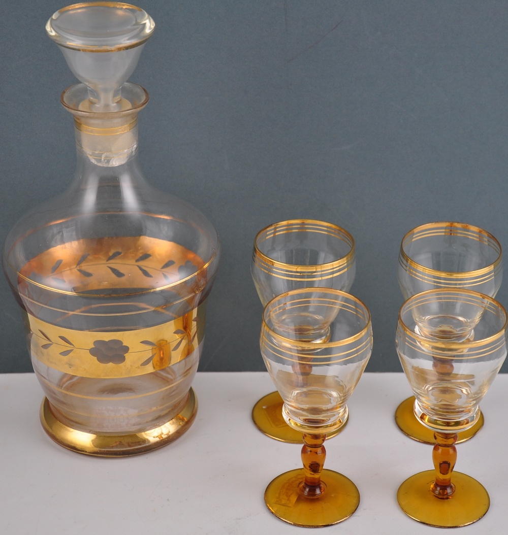 A early 20th Century glass decanter and stopper, with cut gilt band decoration,