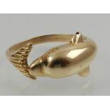 An unusual 14 carat yellow gold ring in the shape of a dolphin.