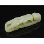 A Chinese jade buckle, fashioned as a mythical creature. W.10cm