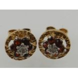 A pair of 9 carat yellow gold, diamond, and garnet cluster earrings.