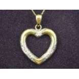 A 9 carat yellow gold heart-shaped pendant suspended on a 9 carat yellow gold chain.