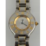 Must de Cartier. A stainless steel and yellow gold ladies wristwatch .