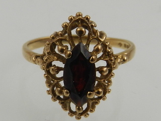 In the antique taste, a 9 carat yellow gold and marquise cut garnet ring.