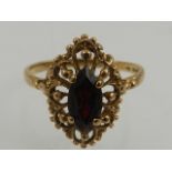 In the antique taste, a 9 carat yellow gold and marquise cut garnet ring.