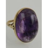 An 18 carat yellow gold and cabouchon amethyst ring.
