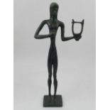 A bronze figure of a young boy holding a harp, raised on a square base. H.28.5cm
