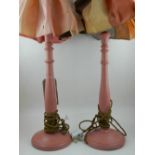 A pair of salmon pink painted treen table lamps. H.67cm