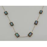 A 9 carat yellow gold and opal beaded necklace.