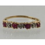 A 10 carat yellow gold, ruby and diamond half eternity ring.
