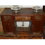An early 20th century walnut pedestal desk, having single drawer flanked by two cupboard doors. H.