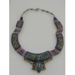 An unusual Tibetan silver, turquoise, coral, and lapis laluni bib necklace.