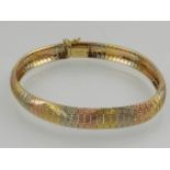 An 18 carat white, rose, and yellow gold segmented bracelet.
