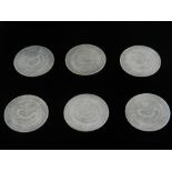 Six Chinese white metal commemorative coins.