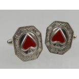 A pair of silver and enamel cufflinks.