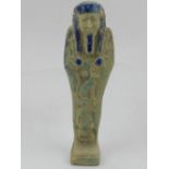 An Egyptian earthenware shabti, partially glazed in indigo, blue and turquoise. H.16cm