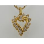 A yellow gold and diamond set heart-shaped pendant, suspended on a yellow gold chain.