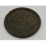 An unusual Chinese bronze circular mirror, the reverse decorated with a phoenix amongst stylised