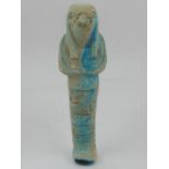 An Egyptian earthenware shabti, partially glazed in turquoise. H.18.5cm