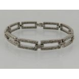 A white gold and diamond open link line bracelet, the stones of approx. 0.50 carats combined.