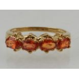 A 9 carat yellow gold and citrine ring, set four oval cut citrine.