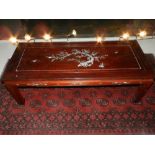A 20th century Chinese hardwood coffee table, having mother of pearl inlay to sides and top,