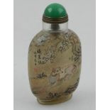 A Chinese reverse glass painted snuff bottle, decorated with greyhounds underneath cherry