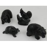 A collection of black carved hardstone animals, to include two bears, a pair of hens, and a