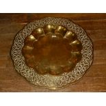 An early 20th century large Indian brass tray, the border decorated with strap-work, the recessed