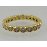 A yellow gold and diamond eternity ring, the stones of approx. 0.90 carats combined.