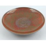 A Chinese red copper and gilt glazed dish, D.12cm