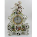 A 20th century Continental porcelain mantle clock, having mounted porcelain cherubs to top,