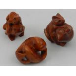 Four carved fruitwood netsukes in the form of a fish, two frogs and two kittens.