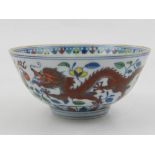 A Chinese Doucai bowl, the exterior decorated with dragons and phoenixes chasing flaming pearls
