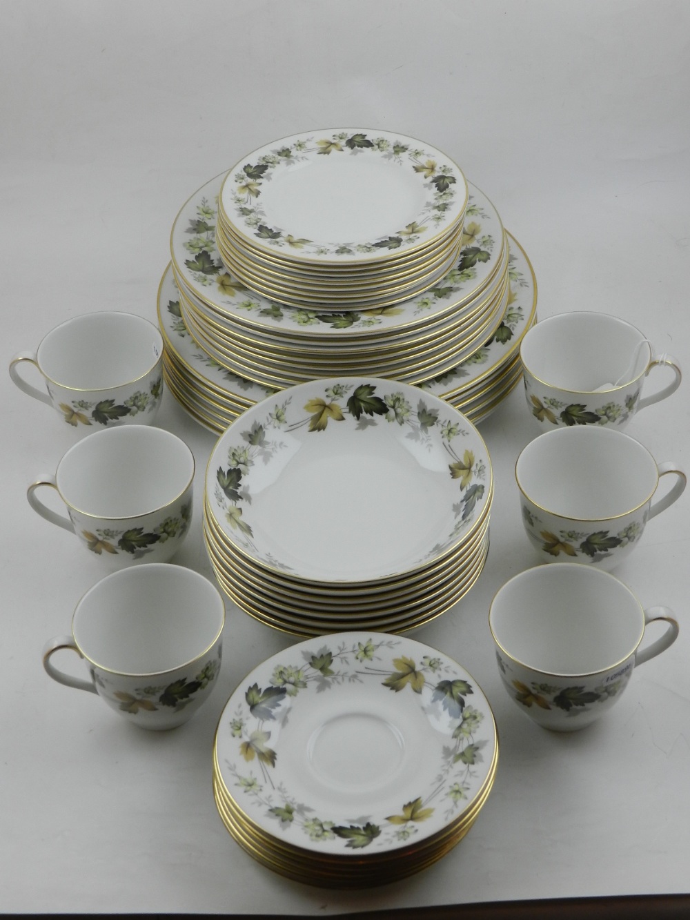 A Royal Doulton part dinner / tea service, pattern Larchmont, the border decorated with a continuous